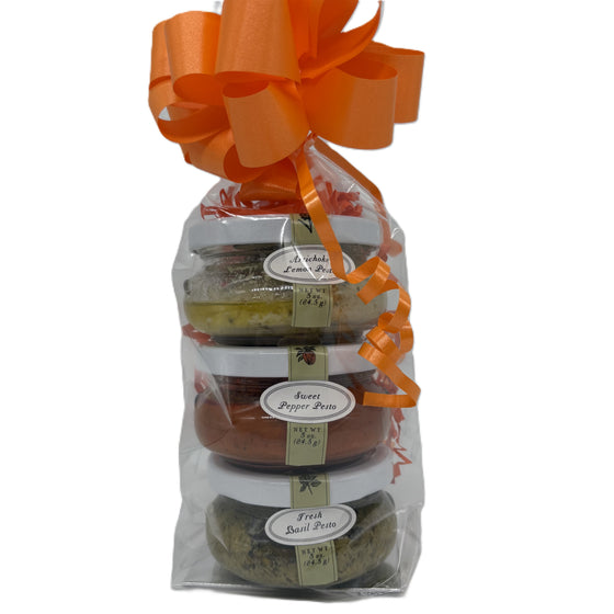 A gift packaged cellophane bag with three 3oz pestos:  artichoke lemon pesto, sweet pepper pesto, and fresh basil pesto.